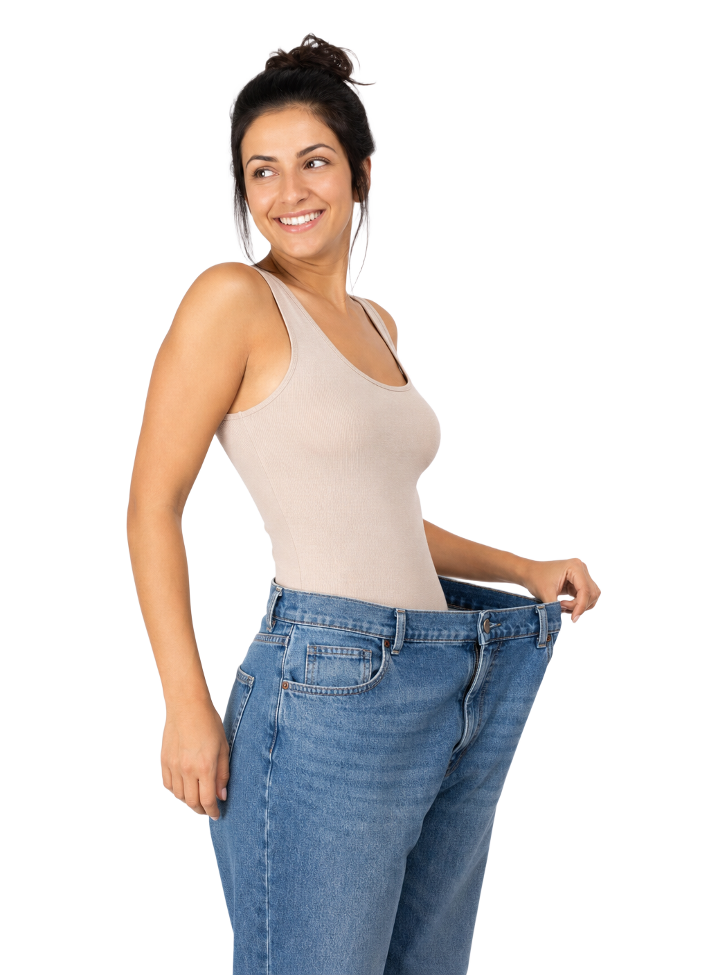 A smiling woman pulling out the waistband of her oversized jeans after weight loss.